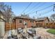 Charming backyard with stone patio, comfortable seating, and string lights for a cozy ambiance at 586 S Corona St, Denver, CO 80209