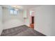 Cozy basement features gray carpet and access to another room with a red brick fireplace at 586 S Corona St, Denver, CO 80209