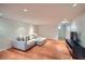 Finished basement featuring hardwood floors, a large sectional sofa, and a media center at 586 S Corona St, Denver, CO 80209