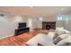 Spacious finished basement featuring a cozy brick fireplace and a large sectional sofa at 586 S Corona St, Denver, CO 80209