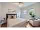 Inviting bedroom features hardwood floors, soft lighting, and neutral decor, perfect for relaxation at 586 S Corona St, Denver, CO 80209