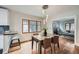 Elegant dining room with modern lighting, hardwood floors, and natural light at 586 S Corona St, Denver, CO 80209