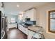 Modern kitchen with white cabinets, stainless steel appliances, and a breakfast bar at 586 S Corona St, Denver, CO 80209