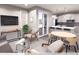 Modern living room with natural light, stylish furniture, and an open layout to the kitchen at 1569 W 166Th Ave, Broomfield, CO 80023