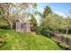 Spacious backyard features a chicken coop, mature trees, and well-maintained garden beds at 12193 W New Mexico Pl, Lakewood, CO 80228