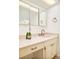 Elegant bathroom with marble countertop, undermount sink, decorative vanity, and modern fixtures at 12193 W New Mexico Pl, Lakewood, CO 80228