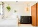 Inviting bedroom with minimalist design, wooden floors, and vintage hanging light at 12193 W New Mexico Pl, Lakewood, CO 80228