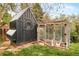 A well-maintained chicken coop and run sit on a grassy lawn, providing a practical space for raising chickens at 12193 W New Mexico Pl, Lakewood, CO 80228