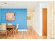 This dining room features wood floors, contemporary decor, and adjacent access to the hallway at 12193 W New Mexico Pl, Lakewood, CO 80228