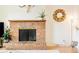 Close-up of the brick fireplace in the living room with wood mantle and decorative accents at 12193 W New Mexico Pl, Lakewood, CO 80228
