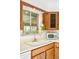 This charming kitchen features wood cabinets, a white sink, and a vintage mint green microwave oven at 12193 W New Mexico Pl, Lakewood, CO 80228