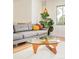 Bright living area with modern glass coffee table, hardwood floors, and comfortable seating at 12193 W New Mexico Pl, Lakewood, CO 80228