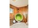 A bright green egg chair and vintage-style decor accentuates a retro-themed interior at 12193 W New Mexico Pl, Lakewood, CO 80228