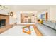 Open-concept living area featuring a brick fireplace and view to dining area at 12193 W New Mexico Pl, Lakewood, CO 80228