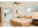 Cozy main bedroom with hardwood floors, large windows, and modern ceiling fan at 12193 W New Mexico Pl, Lakewood, CO 80228