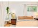 Bright main bedroom features wood floors, large windows, and updated furniture at 12193 W New Mexico Pl, Lakewood, CO 80228
