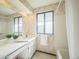 Bathroom features a wide vanity with twin mirrors and a tiled bathtub with shower at 4474 S Vrain St, Denver, CO 80236