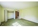 Spacious bedroom features green carpet, closet, and door leading to hallway at 4474 S Vrain St, Denver, CO 80236