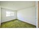 Cozy bedroom features green carpeting and a window with natural light at 4474 S Vrain St, Denver, CO 80236