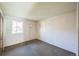 Small bedroom with a window, neutral walls, and carpet tiles at 4474 S Vrain St, Denver, CO 80236