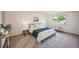 Cozy bedroom with a large bed, soft lighting, and a window providing natural light at 4474 S Vrain St, Denver, CO 80236