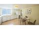 Bright dining room with a glass table, seating for four, and natural light from a large window at 4474 S Vrain St, Denver, CO 80236