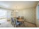 Charming dining room with a wooden table, four chairs, and a chandelier at 4474 S Vrain St, Denver, CO 80236