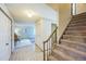 Inviting foyer with a staircase and tiled floor leads to a cozy living area at 4474 S Vrain St, Denver, CO 80236