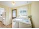 Bright laundry room features a side-by-side washer and dryer and a door leading to the outside at 4474 S Vrain St, Denver, CO 80236