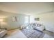 Bright living room with neutral tones, plush seating, and a large window offering natural light at 4474 S Vrain St, Denver, CO 80236