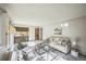 Inviting living room with comfortable seating, natural light, and seamless flow to the kitchen at 4474 S Vrain St, Denver, CO 80236