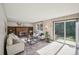 Bright living room with a brick fireplace, built-in shelves, and sliding glass doors to the outside at 4474 S Vrain St, Denver, CO 80236