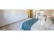 Spacious main bedroom featuring an ensuite bathroom, a queen bed and a calming teal throw blanket at 4474 S Vrain St, Denver, CO 80236