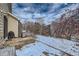 Backyard with patio area features a stainless steel grill and has a serene winter landscape view at 14096 Roaring Fork, Broomfield, CO 80023