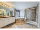 Spacious bathroom featuring a soaking tub, glass-enclosed shower and tiled flooring at 14096 Roaring Fork, Broomfield, CO 80023