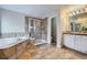 Large bathroom with a tiled shower, soaking tub, and a double sink vanity at 14096 Roaring Fork, Broomfield, CO 80023