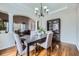 Elegant dining room featuring hardwood floors, a chandelier, and stylish furniture at 14096 Roaring Fork, Broomfield, CO 80023