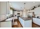 Bright, modern kitchen with white cabinets, gray countertops, stainless steel appliances, and hardwood floors at 14096 Roaring Fork, Broomfield, CO 80023