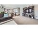 Spacious living room with an entertainment center and open floor plan leading into the kitchen at 14096 Roaring Fork, Broomfield, CO 80023