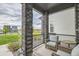 Relaxing front porch with wicker chairs, stone columns, and neighborhood view at 16546 Umatilla Pl, Broomfield, CO 80023