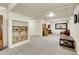 Open basement area with carpet, shelving, and room for a living space at 6360 S Gibraltar Cir, Centennial, CO 80016