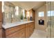 Elegant bathroom featuring double sinks, granite countertops, and modern lighting fixtures at 6360 S Gibraltar Cir, Centennial, CO 80016