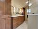 Primary bathroom with double sink vanity, decorative mirror and lighting, and a glass-enclosed shower at 6360 S Gibraltar Cir, Centennial, CO 80016