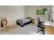Bright bedroom with a bed, desk, and a comfortable rocking chair at 6360 S Gibraltar Cir, Centennial, CO 80016