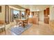 Charming dining area with wood table, chairs, and large windows showcasing a serene outdoor view at 6360 S Gibraltar Cir, Centennial, CO 80016