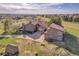 Exterior shot of home showcasing traditional architecture, a long driveway, and landscaping at 6360 S Gibraltar Cir, Centennial, CO 80016