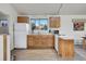 Functional kitchen with ample counter space, wooden cabinets, and white appliances for a clean look at 6360 S Gibraltar Cir, Centennial, CO 80016