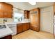 Kitchen with wood cabinets, modern appliances, and a bright window at 6360 S Gibraltar Cir, Centennial, CO 80016