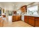 Spacious kitchen with wood cabinets, modern appliances, and a bright window at 6360 S Gibraltar Cir, Centennial, CO 80016