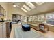 Bright living room with skylights, hardwood floors, and comfortable seating at 6360 S Gibraltar Cir, Centennial, CO 80016